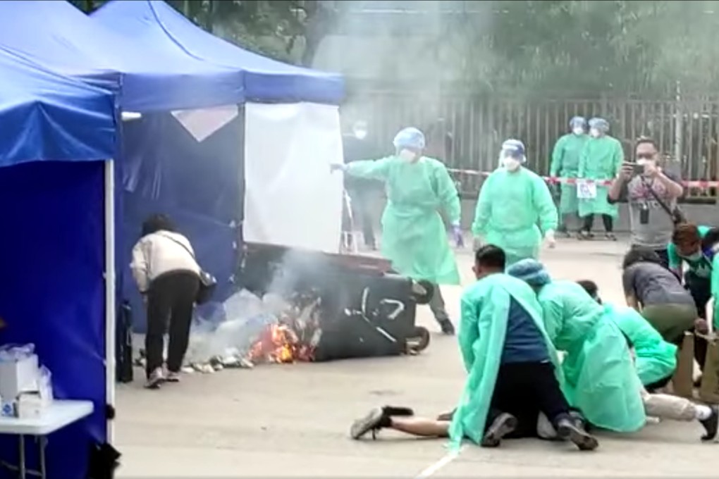 A man was subdued after he allegedly set a bin on fire at Sun Chui Estate testing center in Tai Wai. Photo: Facebook