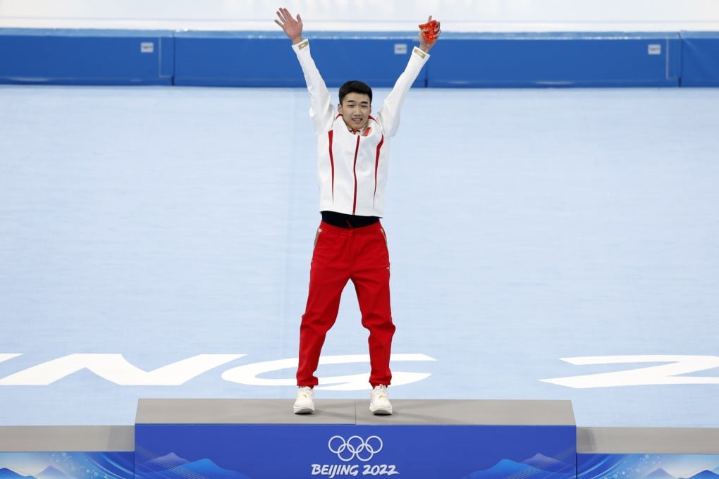China’s Gao Tingyu celebrates on the podium after winning men’s 500m speed skating gold in an Olympic record at the Winter Games. Photo: EPA-EFE