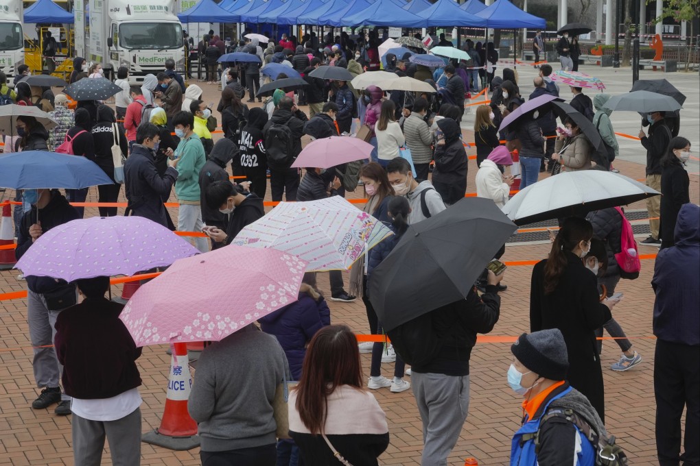 Hong Kong residents line up to get tested for the coronavirus at a temporary testing centre on February 7. Failing to bolster GPs’ role in identifying high-risk patients and developing a pervasive self-testing community have resulted in the current strain on Hong Kong’s health care system. Photo: AP