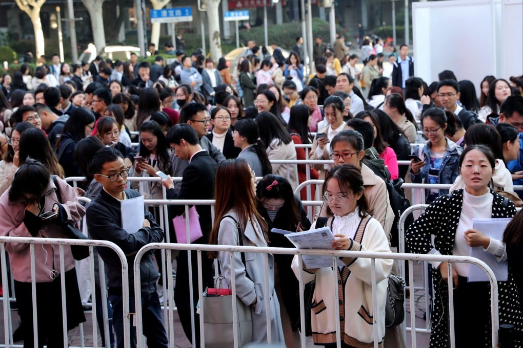 Job seekers wait in line to enter a recruitment fair in Shanghai. Photo: Xinhua