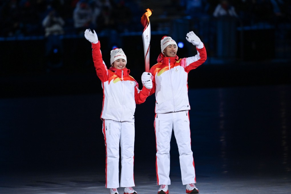 Cross-country skier Dinigeer Yilamujiang (left) was chosen along with Nordic combined skier Zhao Jiawen to carry the Olympic torch during the opening cermony of the Beijing 2022 Winter Games on February 4. Photo: Xinhua