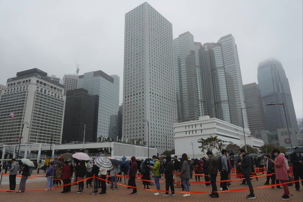 Residents line up to get tested for Covid-19 at a temporary testing centre in the Central district of Hong Kong on February 7. While the pandemic continues to weigh on Hong Kong’s economy, the real estate sector and the office market in particular have outperformed expectations. Photo: AP