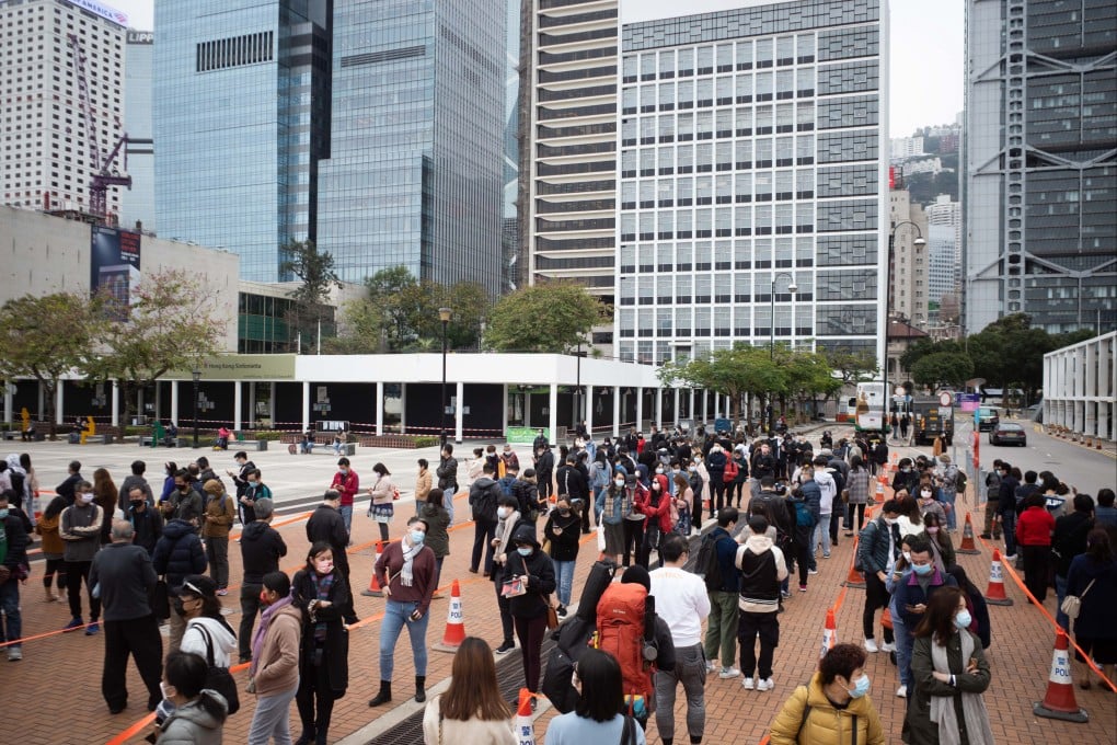 Members of the public wait in line at a Covid-19 testing facility in Hong Kong, where cases are surging. Photo: Bloomberg
