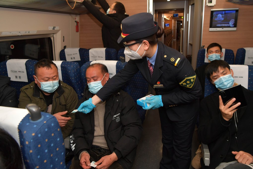 A crew member distributes alcohol pads to passengers on a train from Nanchang of east China’s Jiangxi Province to Shenzhen of south China’s Guangdong Province. China reported 40 imported Covid-19 cases and 40 local cases on Tuesday. Photo: Xinhua