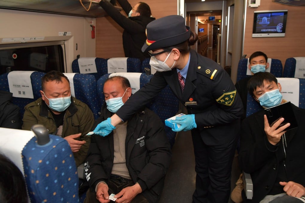 A crew member distributes alcohol pads to passengers on a train from Nanchang of east China’s Jiangxi Province to Shenzhen of south China’s Guangdong Province. China reported 40 imported Covid-19 cases and 40 local cases on Tuesday. Photo: Xinhua
