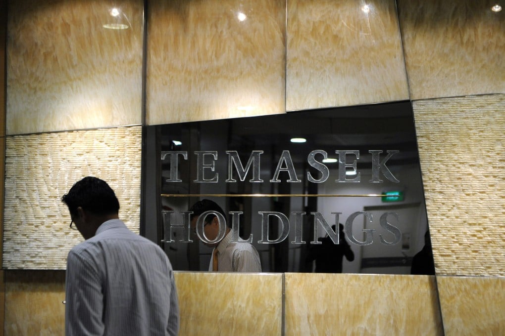 A man walks past the Temasek signboard outside its head office in Singapore. Photo: AFP