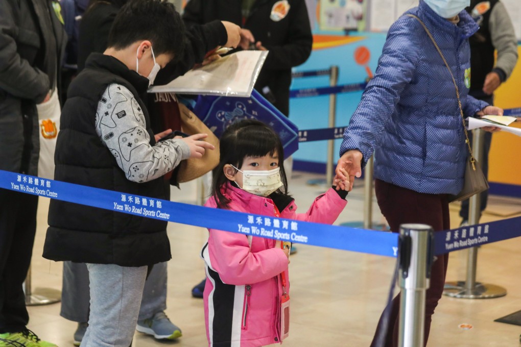 A young girl waits for her first Sinovac jab at Yuen Wo Road Sports Centre in Sha Tin. Photo: Xiaomei Chen