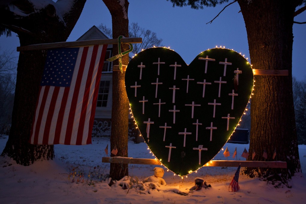 A heart that bears 26 crosses for each Sandy Hook victim is surrounded by lights in Newtown, Connecticut December 2013. Photo: Reuters