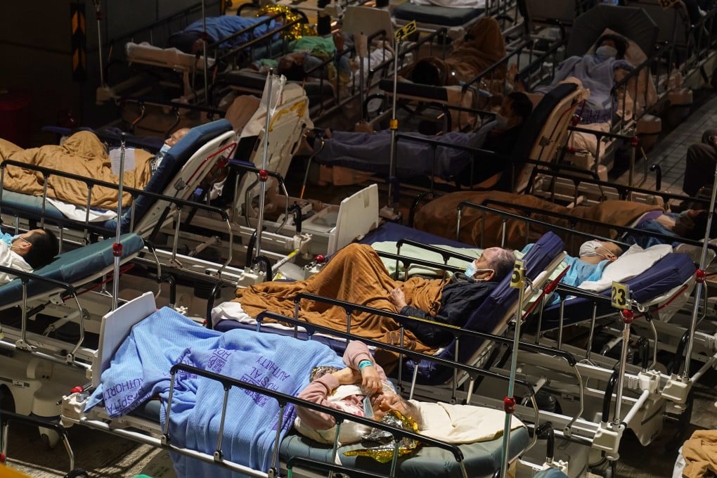 Covid-19 patients wait in a temporary holding area outside Caritas Medical Centre in Cheung Sha Wan. Photo: Sam Tsang