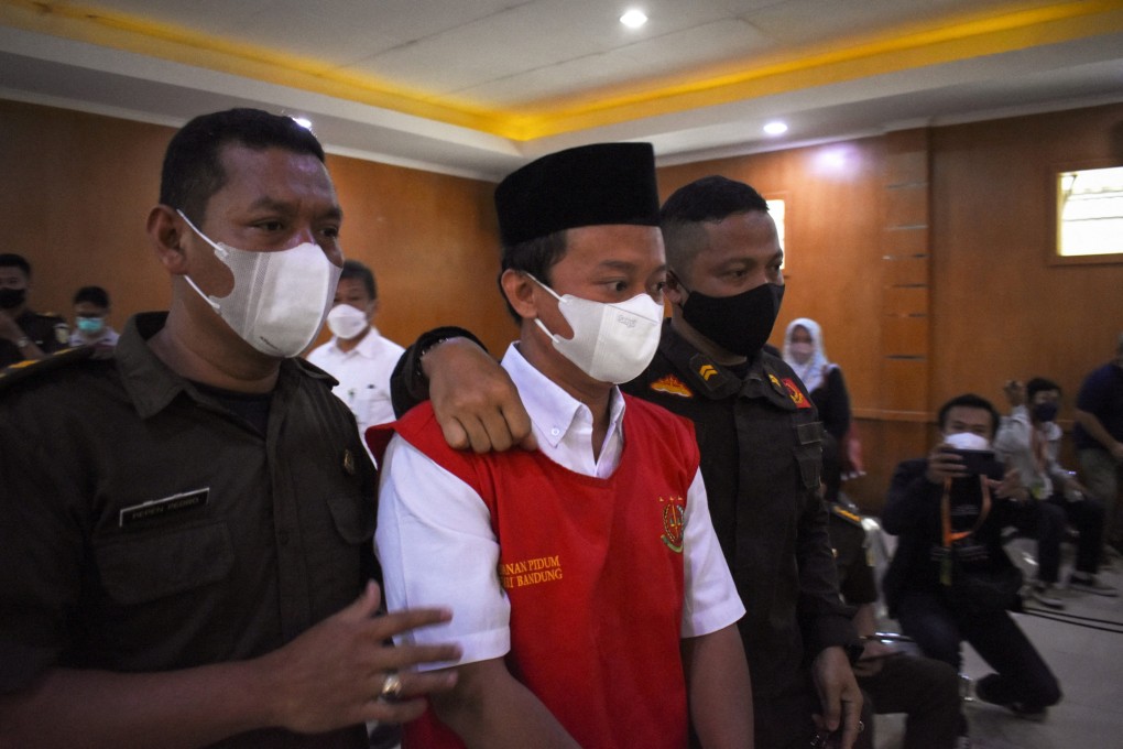 Indonesian teacher Herry Wirawan is escorted to his trial at a court in Bandung, West Java, Indonesia. Photo: AFP