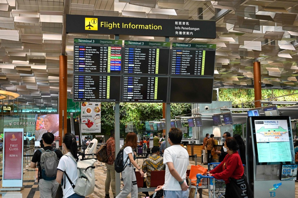 Travellers look at flight information in the departure hall of Singapore’s Changi International Airport. Photo: AFP