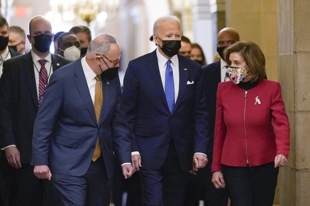 President Joe Biden is flanked by Senate Majority Leader Chuck Schumer of New York, left, and House Speaker Nancy Pelosi of California, right, after arriving on Capitol Hill in Washington on January 6, 2022. Photo: AP