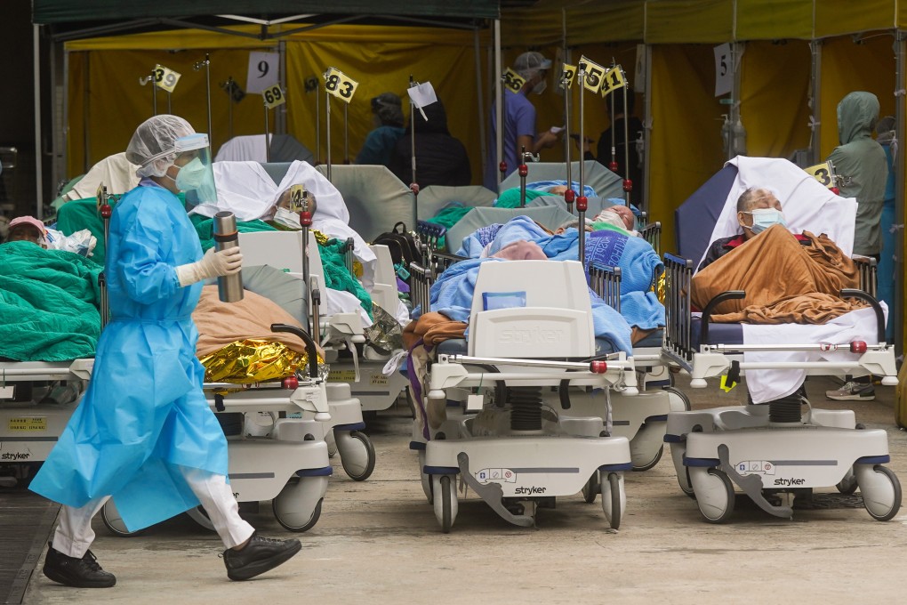 Covid-19 patients wait in a temporary holding area outside Caritas Medical Centre in Sham Shui Po. Photo: Sam Tsang
