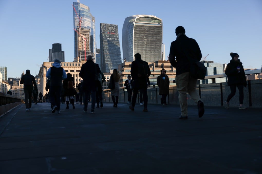 Morning commuters on London Bridge head towards the City of London. The UK is set to scrap the so-called golden visa programme that gives foreign nationals a path to residence. Photo: Bloomberg
