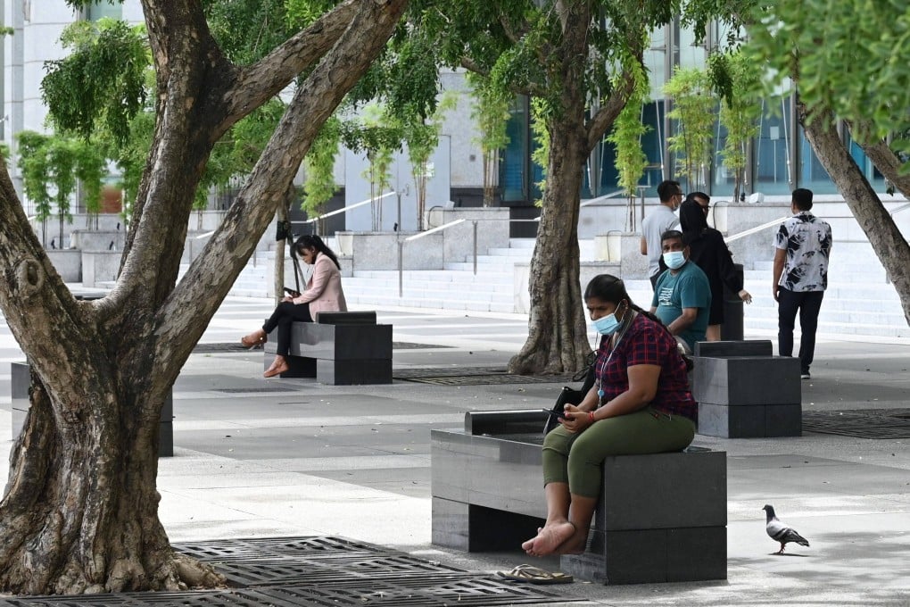 People relax in Singapore’s financial district. Photo: AFP