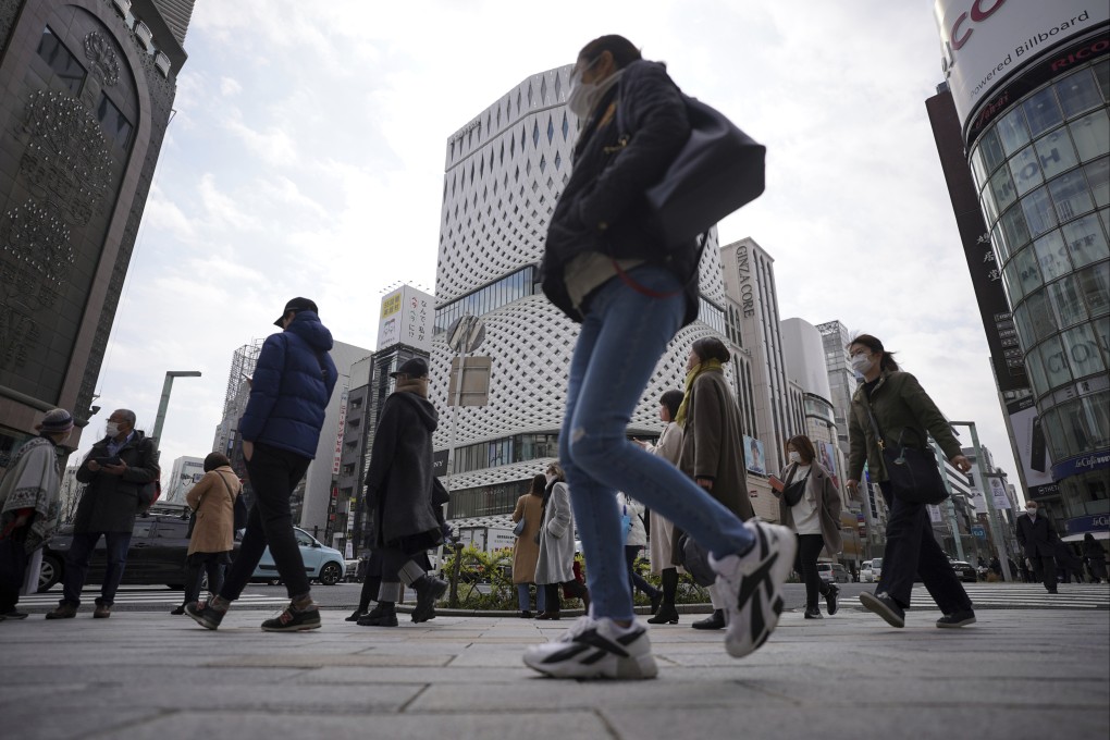 People wear protective masks to help curb the spread of the coronavirus in Tokyo. Photo: AP