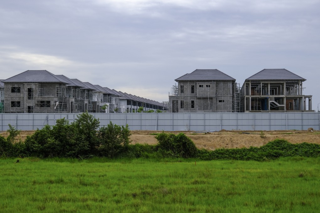 Newly built houses sit on top of a buried  archeological site at Srok Chek near Phnom Penh in Cambodia. Ancient sites across the country are under threat from developers, in contrast to temoles at Angkor and elsewhere that have been preserved. Photo: Peter Ford
