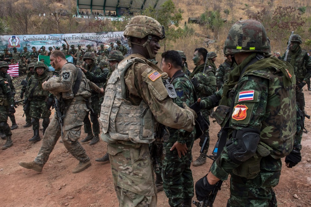 US and Thai soldiers shake hands at the end of a live-fire exercise as part of Cobra Gold in 2017. Photo: AFP