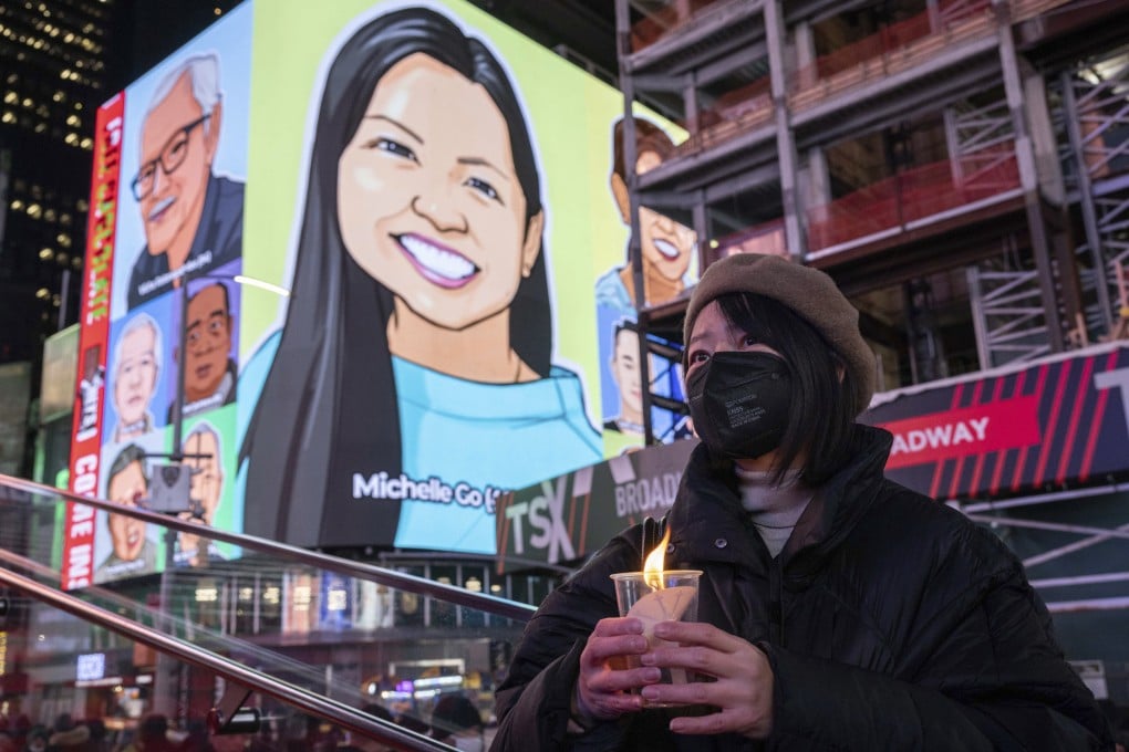 A person holds a candle during a vigil in New York’s Times Square in January in honour of Michelle Alyssa Go, a victim of a subway attack several days earlier. Photo: AP