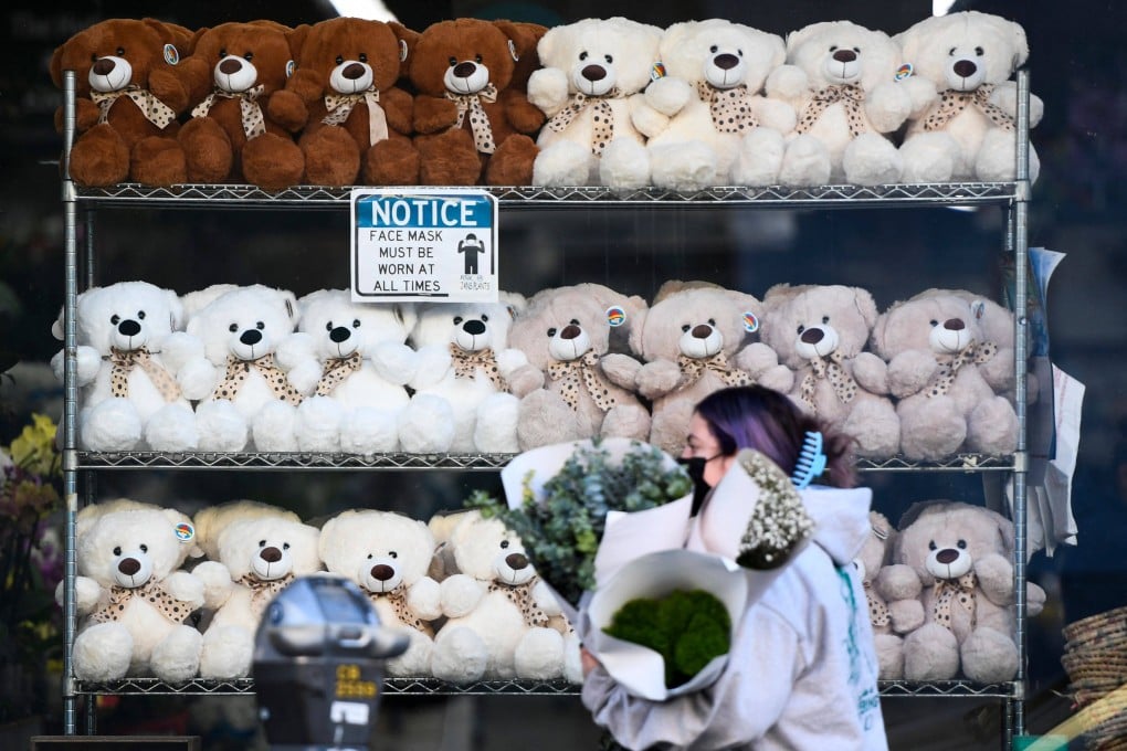 A person carries flowers from a wholesale merchant ahead of Valentine’s Day at the Southern California Flower Market on February 10 in Los Angeles, California. The global supply chain for flowers continues to face shortages and high prices due to the pandemic and climate change. Photo: AFP