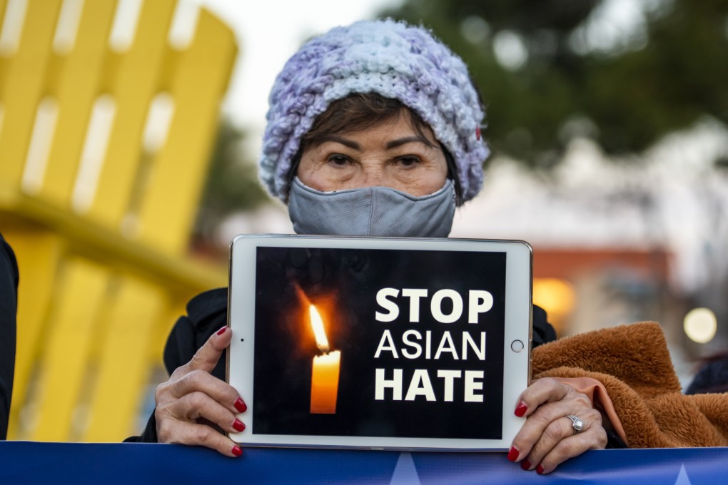 A woman holds up a message in honour of victims of the Atlanta-area spa shootings. Photo: dpa