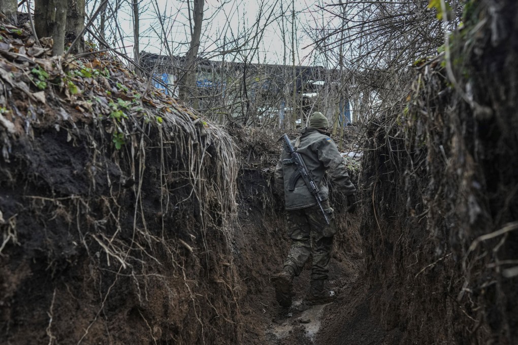 A Ukrainian serviceman walks to check a trench on a position at the line of separation between Ukraine-held territory and rebel-held territory in eastern Ukraine. Photo:  AP