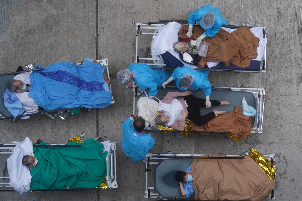 Medical staff treat patients with Covid-19 symptoms at a temporary holding area outside Caritas Medical Centre in Cheung Sha Wan. Photo: Sam Tsang