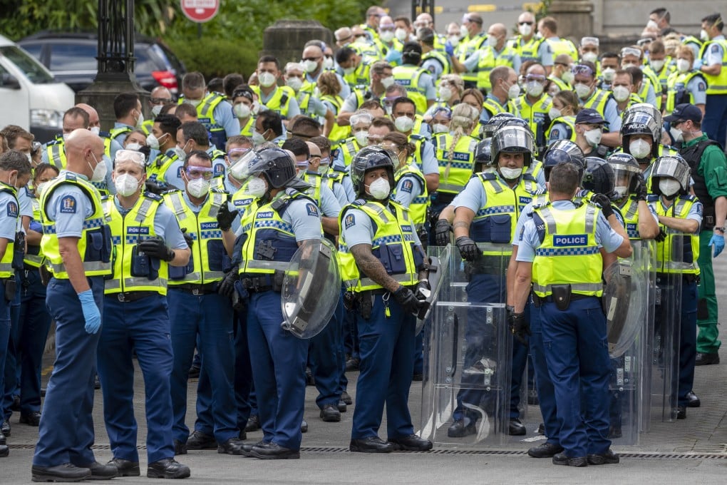 Police, some in riot gear, gear up to move concrete barricades on Day 15 of the anti-mandate protests in Wellington. Photo: NZ Herald