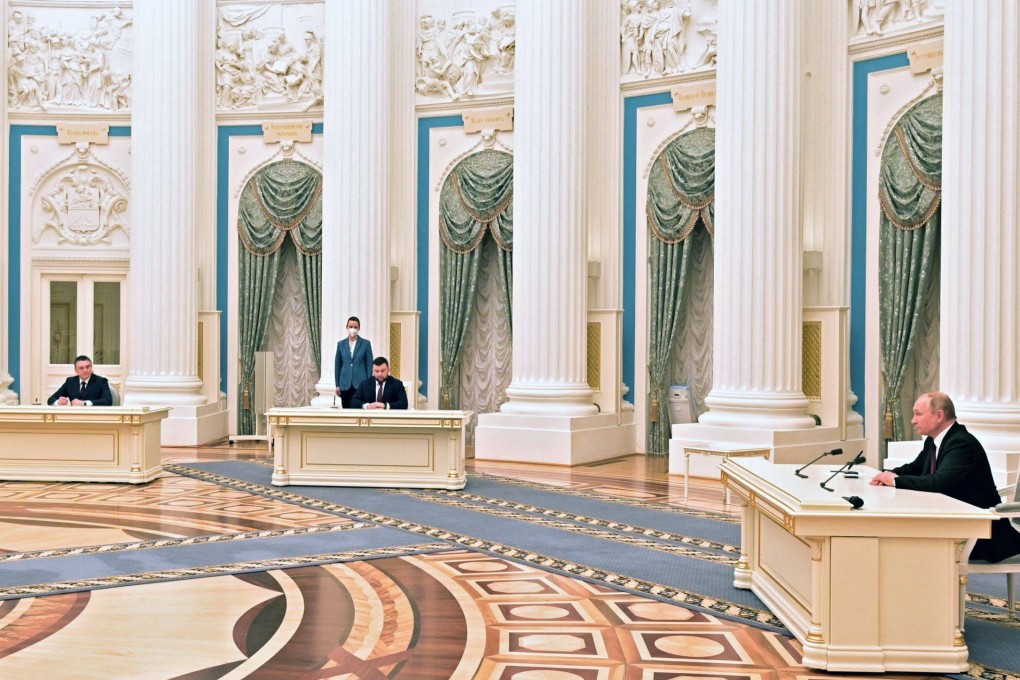 Russian President Vladimir Putin (right) attends a ceremony to sign documents, including a decree recognising two Russian-backed breakaway regions in eastern Ukraine as independent, with the leaders of the self-proclaimed republics Leonid Pasechnik (left) and Denis Pushilin (centre) during a ceremony at the Kremlin in Moscow on February 21. Photo: Sputnik/AFP