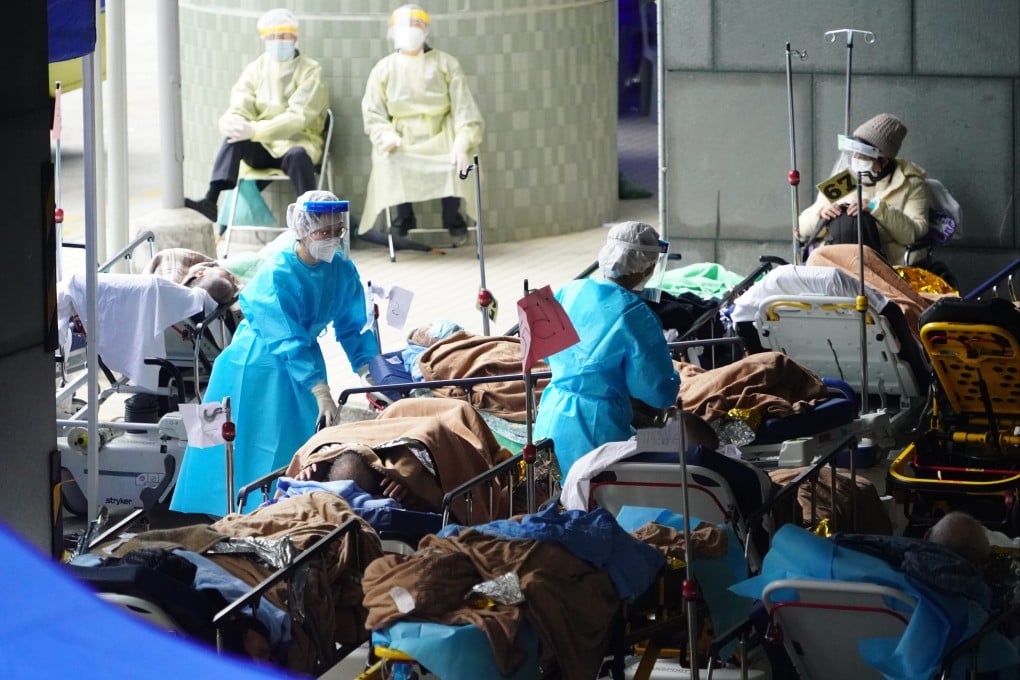 Patients with Covid-19 symptoms lie in beds at a temporary holding area outside Caritas Medical Centre in Cheung Sha Wan on February 18. Photo: Felix Wong