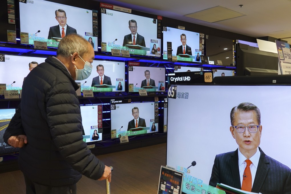 An elderly resident watches Financial Secretary Paul Chan’s live broadcast of the 2022-23 budget. Photo: Robert Ng