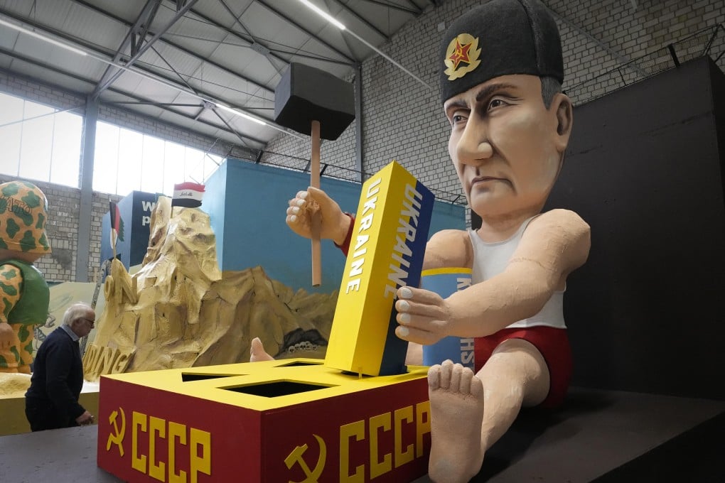 A carnival float depicts Russia’s President Vladimir Putin playing with building blocks like the Ukraine to restore the Soviet Union is seen at the Rose Monday Parade in Cologne, Germany on Tuesday. Photo: AP