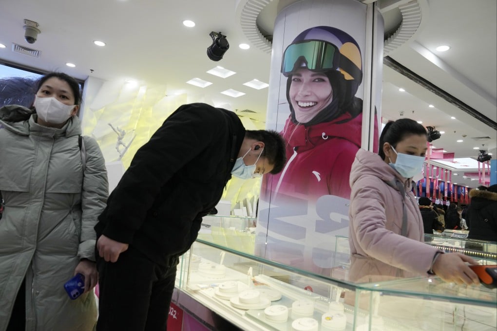 An advertisement with Olympics gold medalist Eileen Gu in Anta sportswear at a counter selling official Games merchandise in Beijing on February 19, 2022. Photo: AP