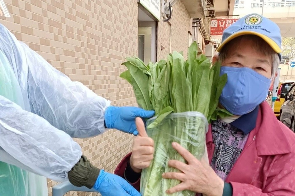 An elderly woman collects food from a Food Angel station. The Hong Kong charity has had to suspend many of its services since the city was hit by its fifth Covid-19 wave. Photo: Courtesy of Food Angel
