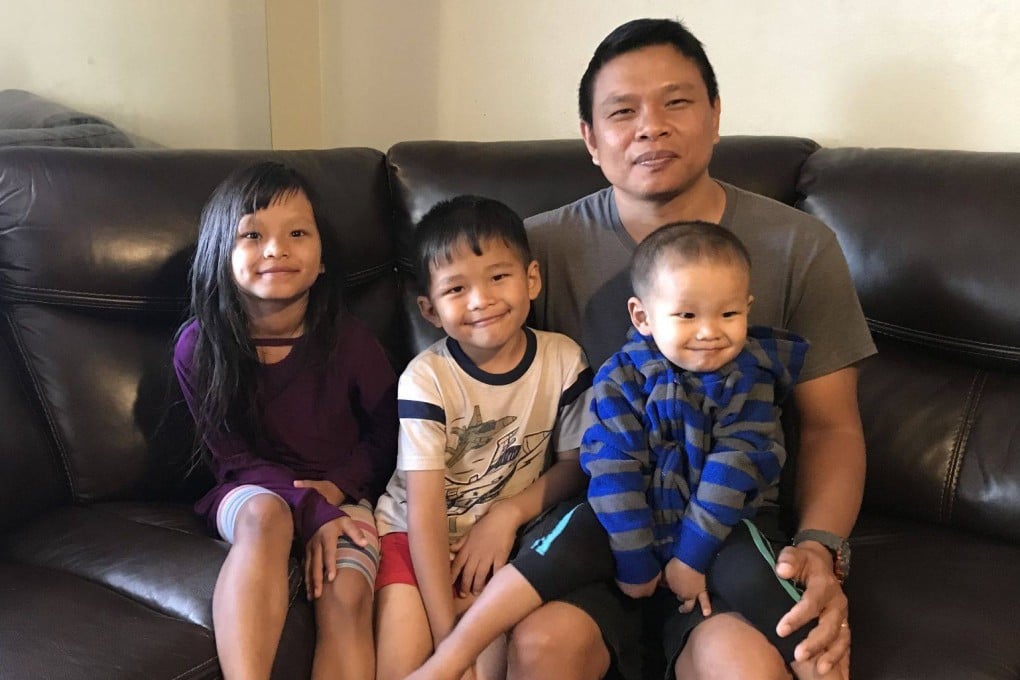 Bawi Cung, right, seated with his children at home, before he and his two sons were stabbed in an anti-Asian attack last March 2020 at Sam’s Club in Midland, Texas. File photo: Bawi Cung via AP