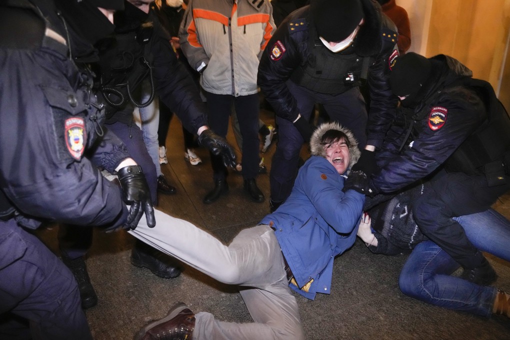 Police officers detain demonstrators in St Petersburg, Russia on Thursday. Photo: AP