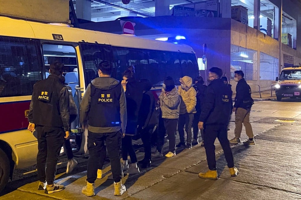 Hong Kong police take 22 people into custody after a raid on an illegal gambling den in Tsuen Wan. Photo: Handout