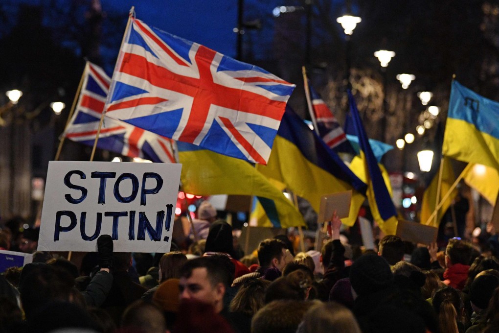 People stand with placards and Ukrainian and Union flags at a demonstration in London on Thursday to protest against Russia’s invasion of Ukraine.  Photo: AFP