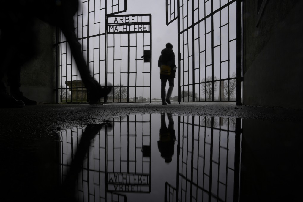 People enter the Sachsenhausen Nazi death camp through the gate with the phrase “Arbeit macht frei” (work sets you free) in Oranienburg, about 30km north of Berlin, Germany, on January 25. Photo: AP