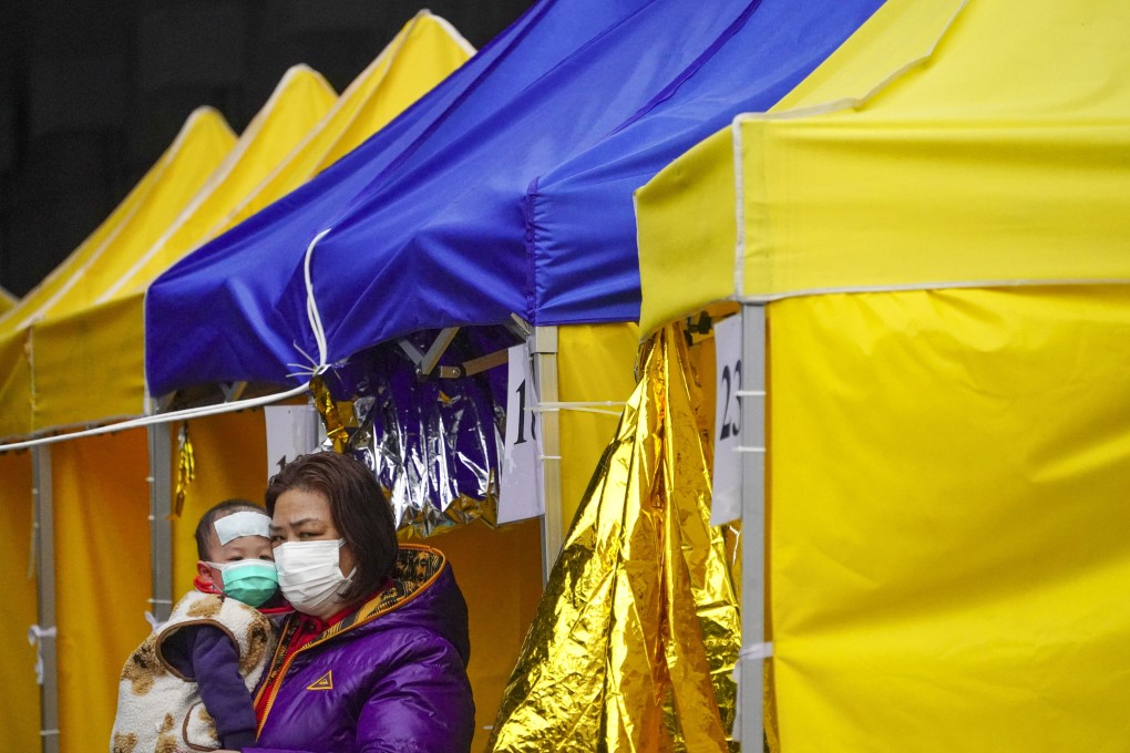 Covid-19 patients wait for admission in a holding area outside Caritas Medical Centre in Cheung Sha Wan. Photo: Felix Wong