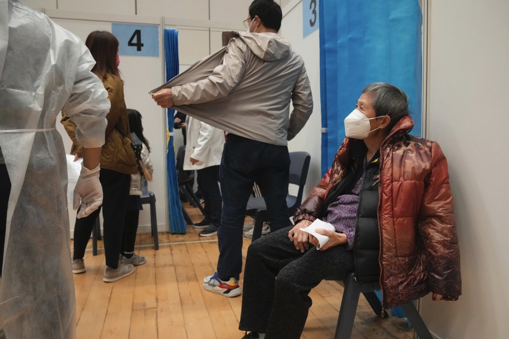 An elderly woman waits to receive a Covid-19 vaccine dose at a community vaccination center in Hong Kong on February 25. Hong Kong should bring vaccinations to the doors of the elderly. Photo: AP