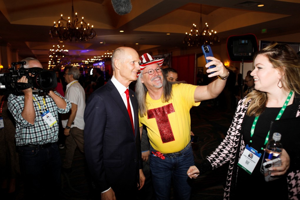Florida Senator Rick Scott takes a selfie with a Trump supporter at the Conservative Political Action Conference in Orlando, Florida on February 26. Photo: Reuters