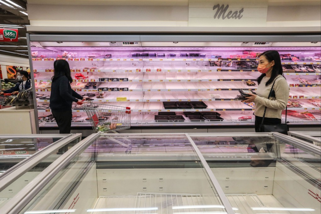 Empty shelves are seen at a supermarket in Fortress Hill on Tuesday as residents stock up on supplies such as frozen food and hygiene items. Photo: Jelly Tse