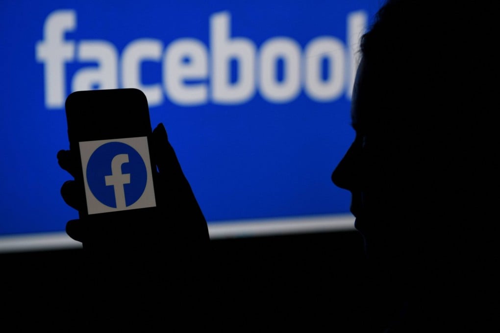 In this file illustration photo taken on April 7, 2021, a smart phone screen displays the logo of Facebook on a Facebook website background. Photo: AFP