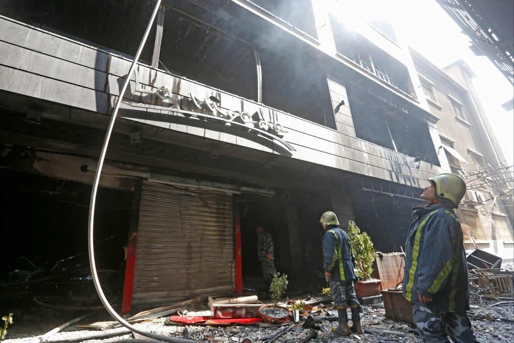 Firefighters at the scene of a fatal blaze that broke out in a shopping centre in the Syrian capital Damascus on Tuesday. Photo: AFP