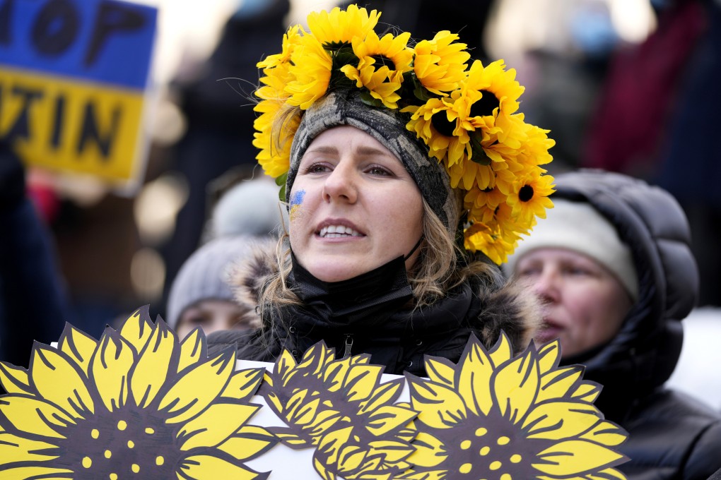 A protester wearing a crown of sunflowers rallies against Russia’s invasion of Ukraine in Ottawa, Canada on Sunday. Photo: The Canadian Press via AP