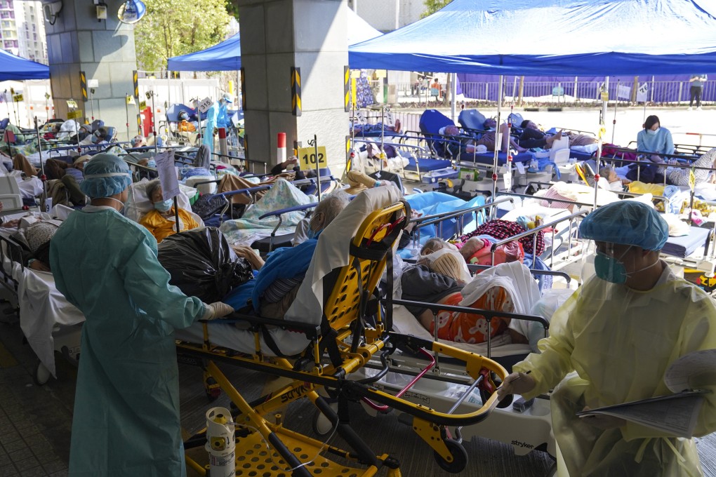 Patients with Covid-19 symptoms wait at a temporary holding area outside Caritas Medical Centre in Cheung Sha Wan on February 27. Photo: Sam Tsang