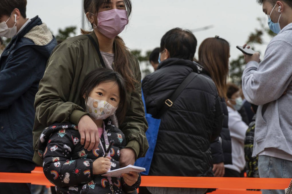 Mother and daughter queue up for Covid-19 PCR tests at a testing centre in the Central financial district in Hong Kong on February 9. Photo: Getty Images