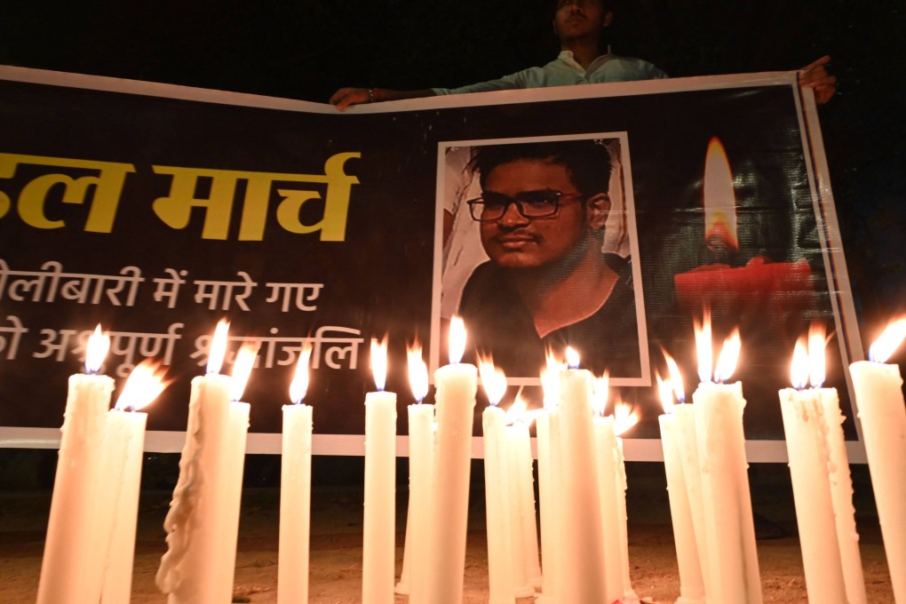 Activists from the Indian Youth Congress take part in a candle lighting in New Delhi on Tuesday for the Indian student who was killed in shelling in Ukraine. Photo: AFP