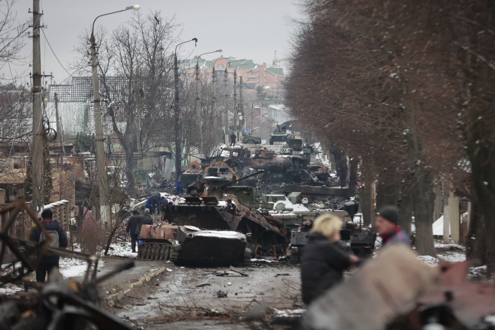 People look at the gutted remains of Russian military vehicles on a road in the town of Bucha, close to the capital Kyiv, Ukraine, Tuesday, March 1, 2022. Photo: AP Photo